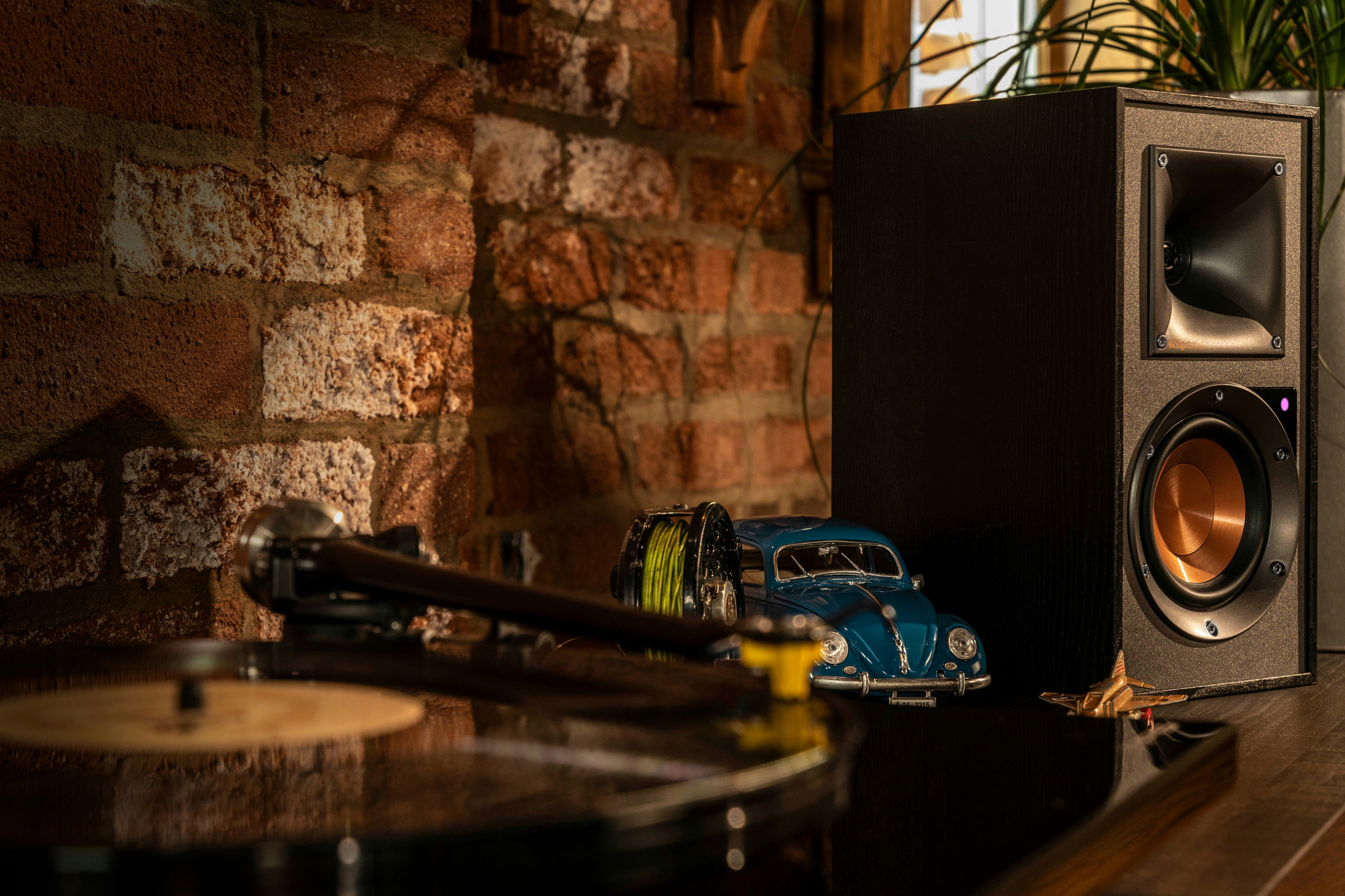 Reference Powered Speaker next to a vinyl record player